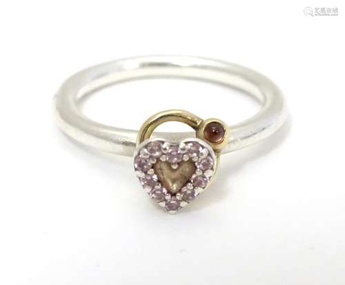 A silver ring with heart detail Please Note - we do not make reference to the condition of lots