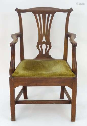 A late 18thC / early 19thC mahogany open arm chair with a shaped top rail, Chippendale back splat