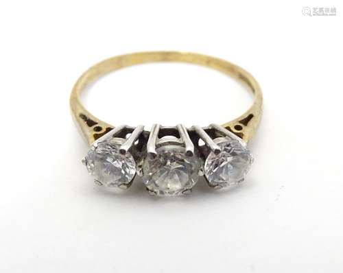 A 9ct gold ring set with trio of cubic zirconia to top. Ring size approx P 1/2 Please Note - we do