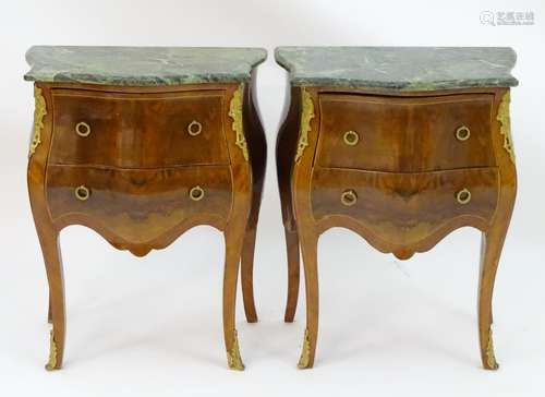 A pair of late 20thC bombe commode style cabinets, with serpentine shaped marble tops above two