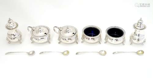 An extensive silver cruet set comprising two mustard pots, two salts and two pepperettes