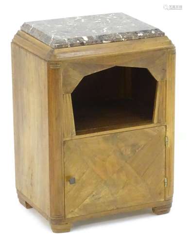 An early / mid 20thC walnut bedside cabinet with a marble top above a canted under tier and