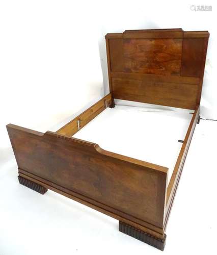 An Art Deco oak and walnut double bed with ebonised stringing and gadrooned feet. 82