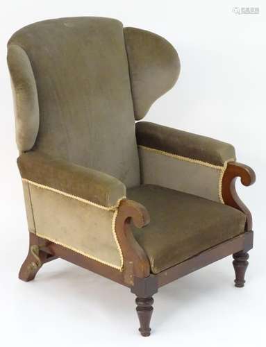 A Victorian wingback adjustable armchair with scrolled arms, mechanical crank to one side and raised