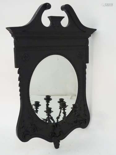 A Victorian painted girandole with a swan neck pediment central oval mirror with a bevelled edge,