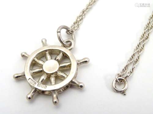 A hallmarked silver pendant on sterling silver chain, the pendant formed as a ship's wheel.