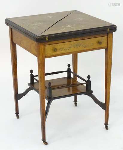 A late 19thC / early 20thC envelope card table with marquetry detailing, opening to show dished