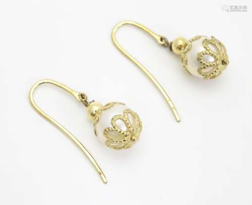 A pair of 9ct gold earrings set with pearl drops. Approx 1