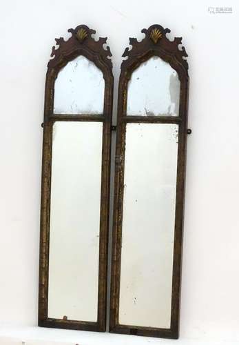 A pair of 18thC walnut mirrors with shaped tops, carved shell decoration and the mirrors having