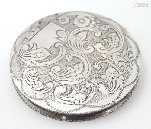 A Continental white metal .833 powder compact with engraved decoration. Approx. 2 1/4