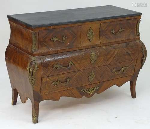 A late 20thC kingwood bombe commode with an ebonised top above three long drawers with ormolu