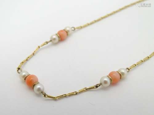 A 9ct gold necklace set with pearl an coral beads. Approx 16