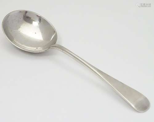 A silver ladle with Royal coat of arms to back of bowl. Hallmarked Sheffield 1936 maker Roberts &