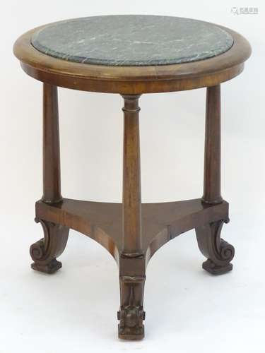 A mid 19thC mahogany Empire style centre table, having a circular marble inset to the centre above