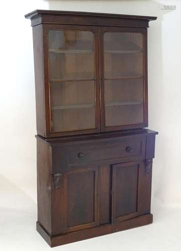 A Victorian mahogany secretaire bookcase, with a moulded cornice above two glazed doors with a