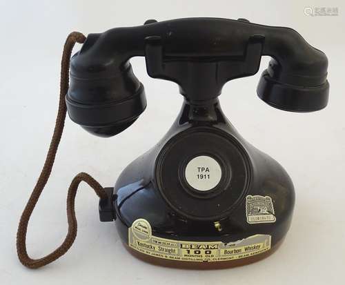 A novelty advertising decanter for Jim Beam bourbon whiskey, formed as a '1928 French phone',