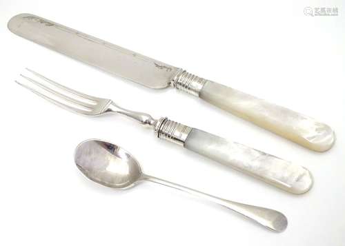 A knife and fork with silver collars and mother of pearl handles, hallmarked Sheffield 1921.