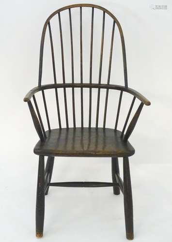 A late 19thC double bow back Windsor chair raised on turned tapering legs united by a H stretcher.