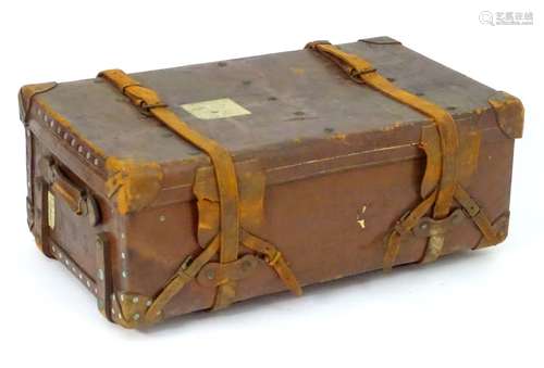 A late 19thC leather bound travelling trunk with studded detail and flanked by carrying handles. 38