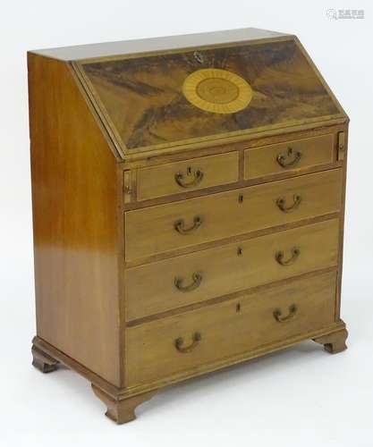 A late 19thC mahogany bureau with an inlaid, crossbanded fall front opening to show a fitted