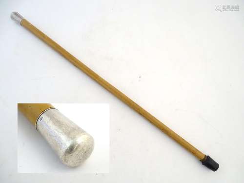 A late 19th-early 20thC walking cane, mallaca shaft with ferrule and white metal knop. 33