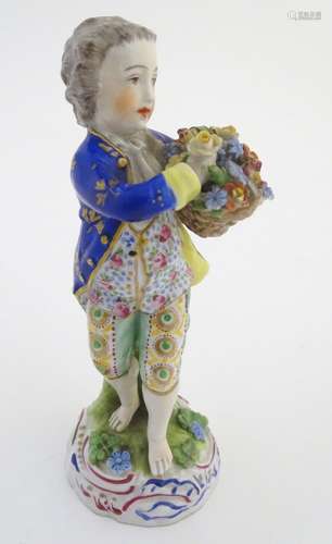 A Dresden porcelain figure of a boy with a basket of flowers. Marked under. Approx. 5 1/4