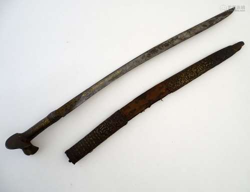 Militaria: an 18thC Ottoman Yataghan sword and scabbard, the patinated brass hilt with a prominent