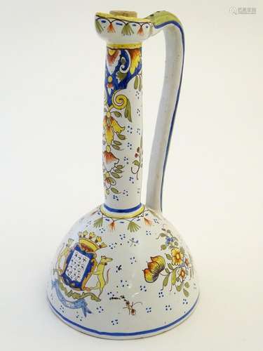 A French faience / maiolica ewer with floral decoration and armorial to the body. Marked 9663