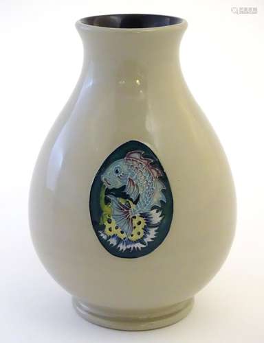 A Moorcroft trial vase in the shape 7/5, decorated with a fish and thistle design. Impressed mark