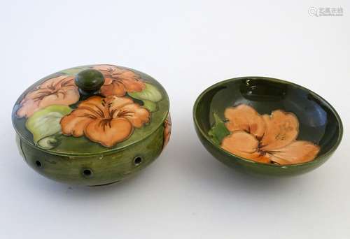 A Moorcroft pot pourri pot and cover in the pattern Hibiscus. Together with a circular dish in the