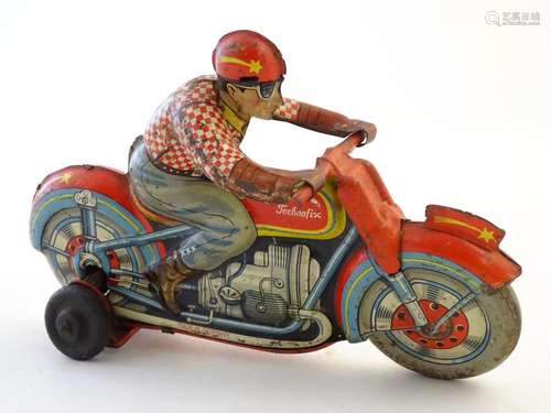 Toy: A Technofix tin clockwork motorcycle and racer. The wheel is marked Metzeler Cord 25 x 9.