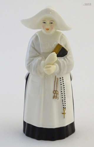 A Royal Worcester figural candle snuffer modelled as a nun. Marked within. Approx. 3 3/4