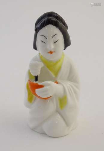 A Royal Worcester figural candle snuffer modelled as a Japanese girl. Marked within. Approx. 3