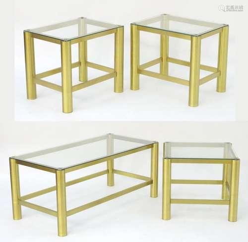 A collection of brass and glass coffee tables, comprising a pair of end tables, a long rectangular