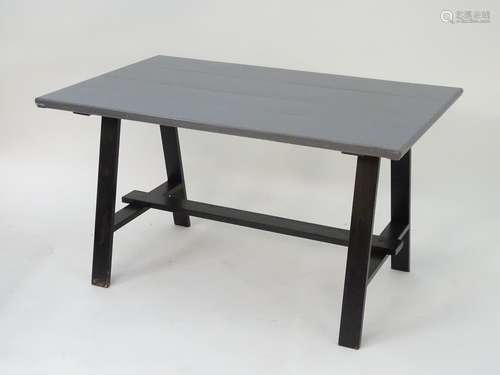 A mid 20thC tavern table with a four plank painted hardwood top above a metal base. 53