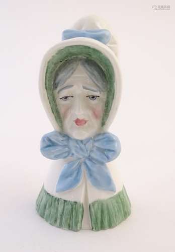 A Royal Worcester figural candle snuffer modelled as an old woman. Marked within. Approx. 3 1/2