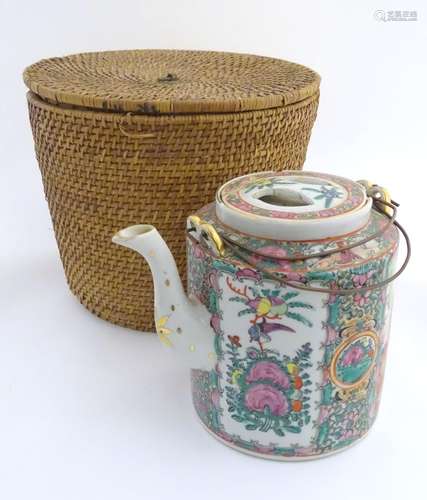 A Chinese Cantonese teapot and cover with famille rose decoration with panelled decoration depicting