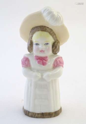 A Royal Worcester figural candle snuffer modelled as a young girl wearing a hat, titled Feathered