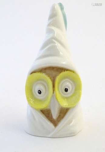 A Royal Worcester figural candle snuffer modelled as an owl wearing a nightcap. Marked within.