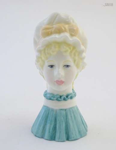 A Royal Worcester figural candle snuffer modelled as a young woman wearing a bonnet, titled Mob Cap.