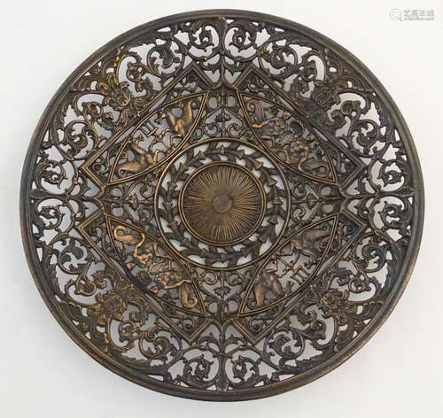 A cast Coalbrookdale charger with pierced Neoclassical style decoration with mythical hippocampi,