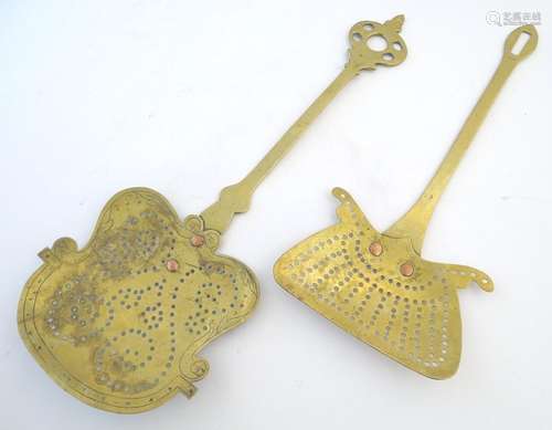 Two Georgian brass skimmers, both shaped and pierced with two copper rivets securing the handle to