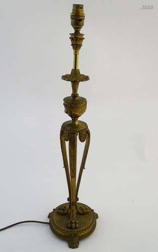 Lighting: an Edwardian gilt brass table lamp, the urn dish and column supported by three scrolling