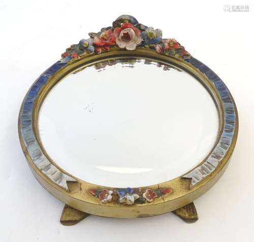 A 20thC Barbola circular easel back dressing table mirror with floral decoration in relief.