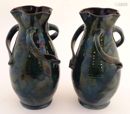 A pair of Baron Barnstaple art nouveau vases in a lustre glaze, with lobed rims and three twisted