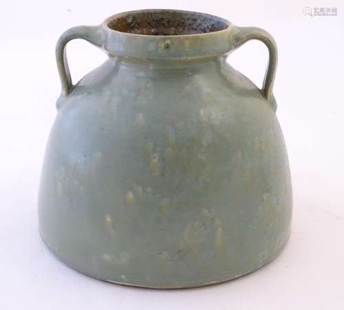 A Brannam of Barnstaple twin handled squat vase with a mottled green glaze. Impressed C H Brannam