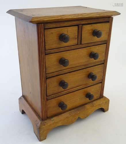 An early 20thC pine apprentice piece / miniature chest of drawers, two over three drawers. Approx.