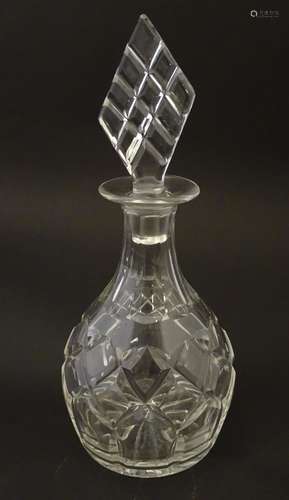 Glass: an early-to-mid 19thC squat decanter, decorated with diamond cuts, the tapering neck with