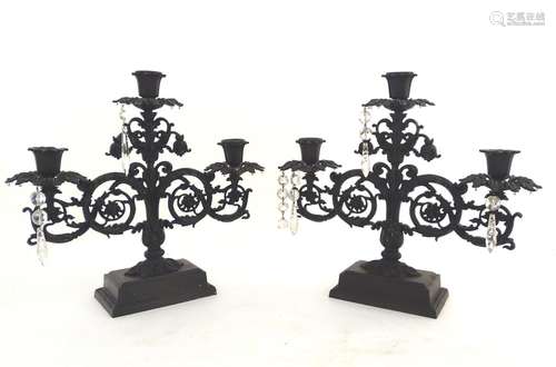 A pair of late-20thC candleabra, of cast iron construction with acanthus styling and provision for