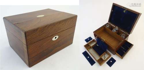 A late Victorian rosewood travelling vanity case, the interior lined in cushioned blue velvet with